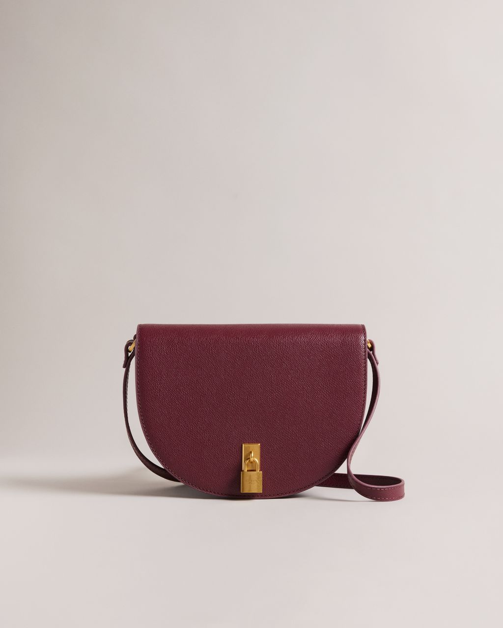 women's leather padlock saddle bag in purple, sohho