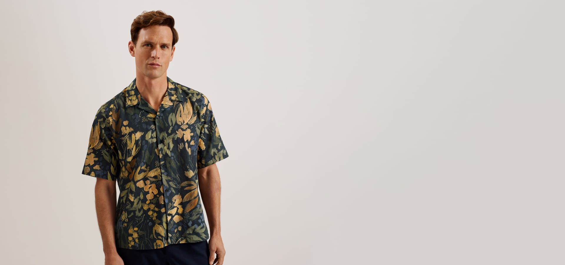 Man in a floral short sleeve shirt
