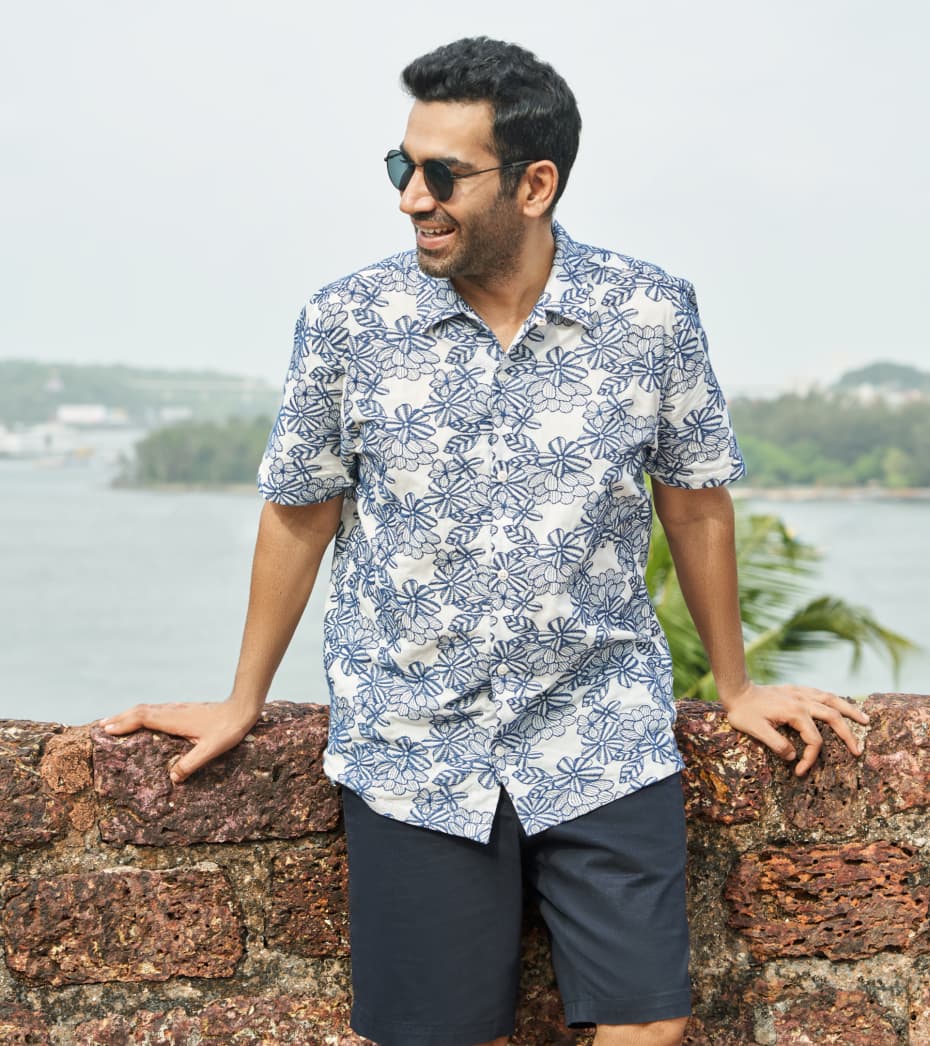 Man leaning on wall in floral Ted Baker shirt