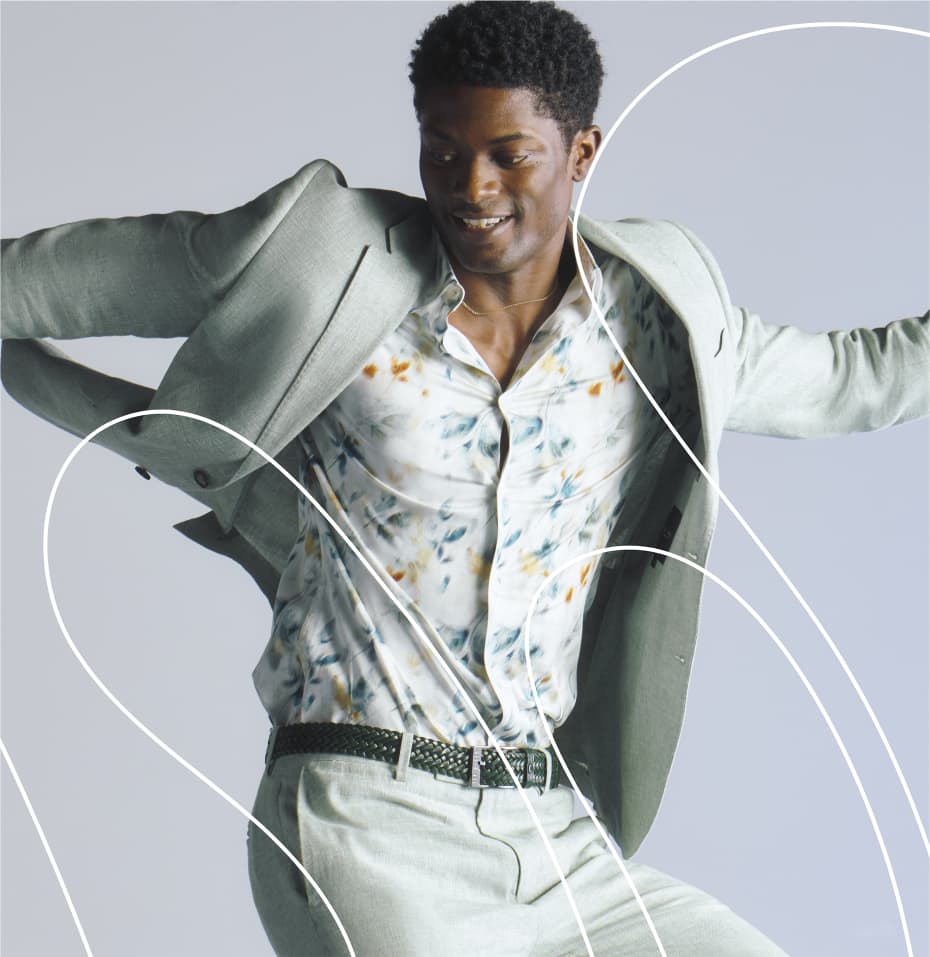 Man in a floral print shirt with light suit jumping