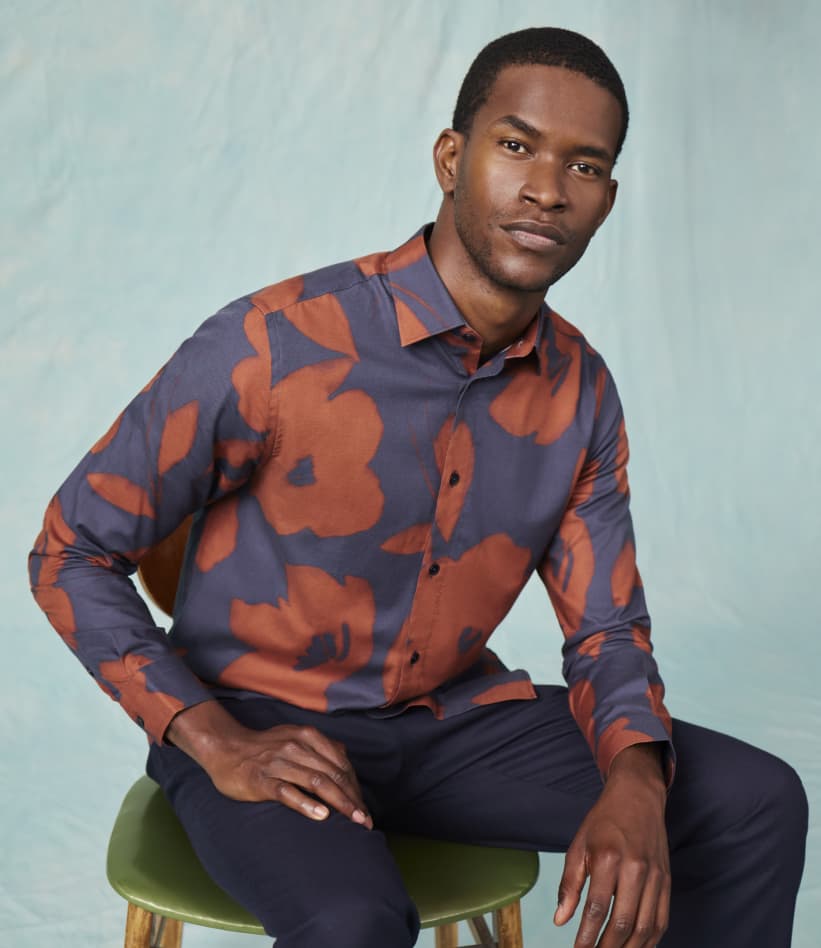 Man in navy and orange printed long sleeve Ted Baker shirt
