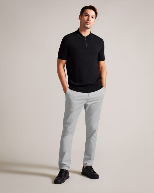 Man In a grey trousers and black zipped top