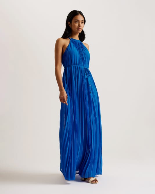 Woman in blue pleated dress