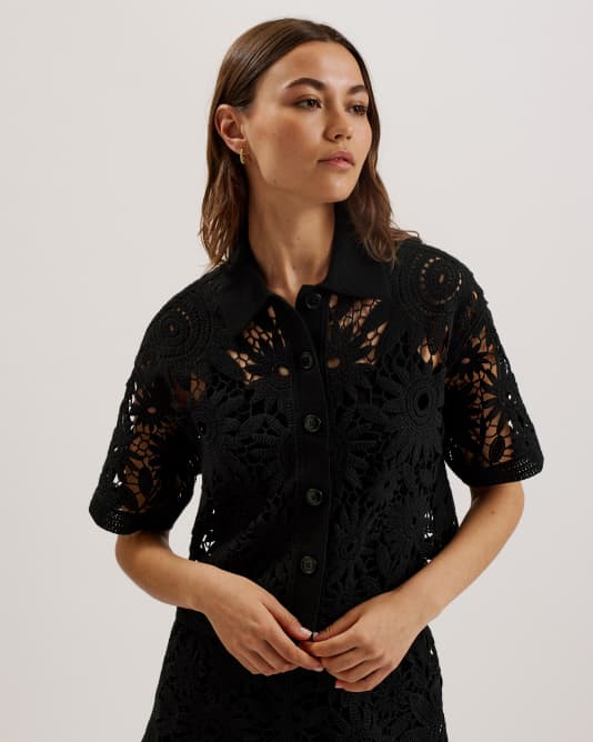 Woman in a black crochet boxy shirt