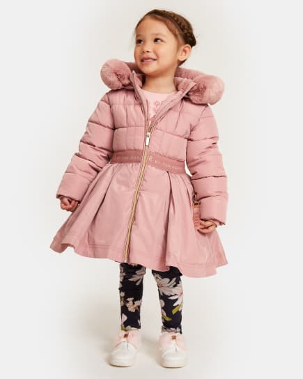 Girl in a pink coat with pleated skirt