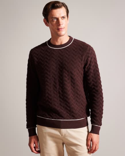 Man in a red long sleeve knitted top