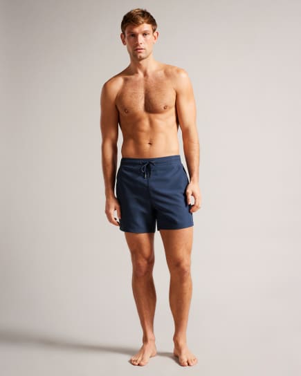 Man in navy swim shorts