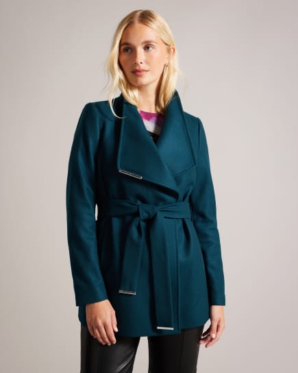 Woman in teal green coat