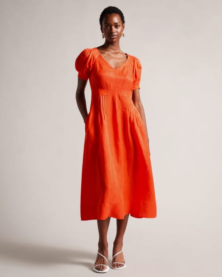 Woman wearing a bright orange dress