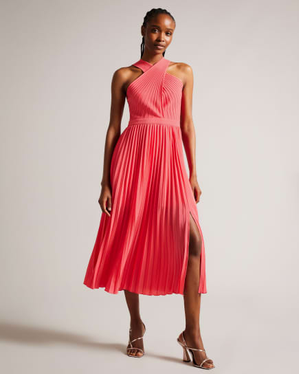 Woman wearing a pleated coral dress