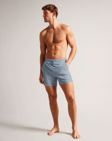 Man in geometric blue shorts