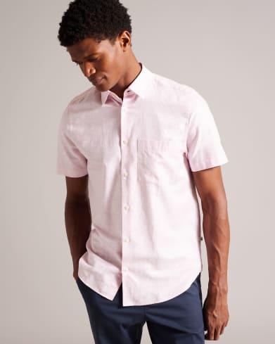 Man in a pink linen shirt