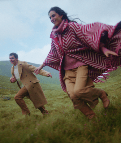 Autumn winter collection - couple running on hill
