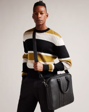 Man in stripy jumper carrying black laptop bag