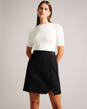 Woman in a mini dress with boucle skirt and knit white top