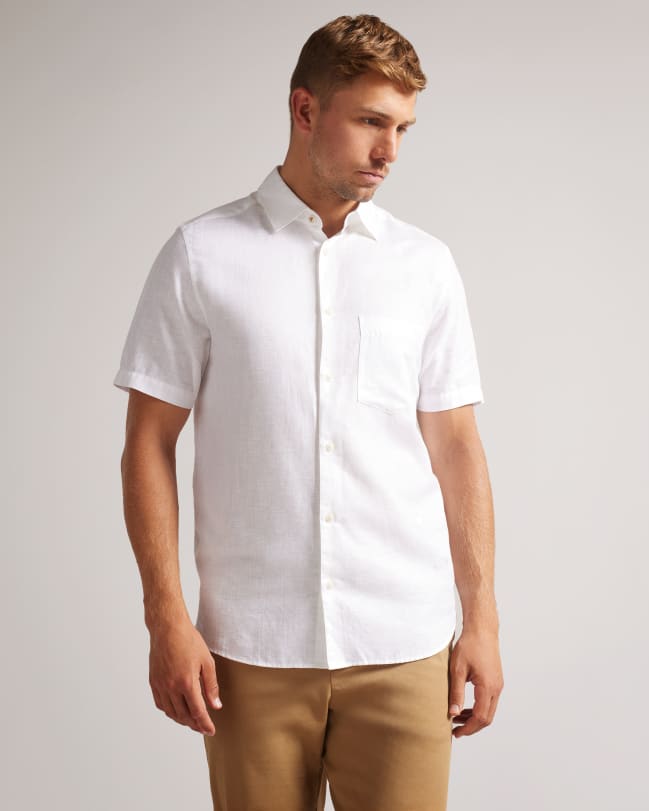 Man in a cream short sleeve linen shirt