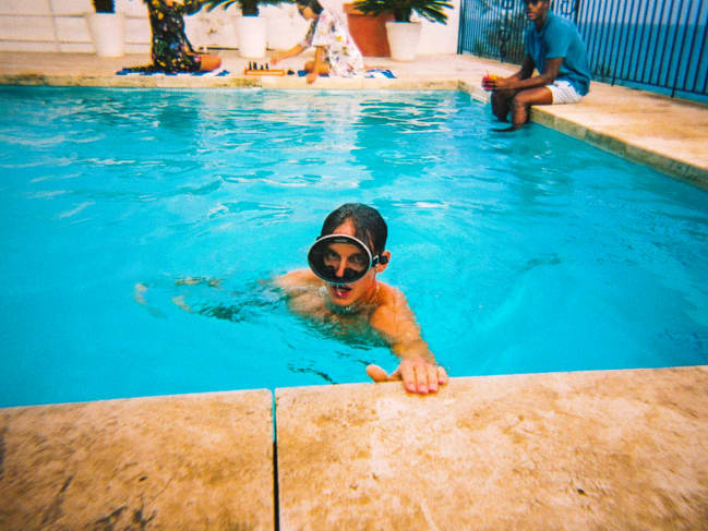 Man in pool with snorkeling goggles on