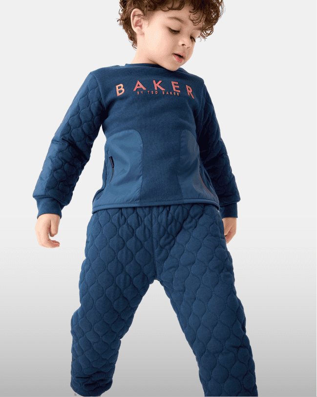 Younger boy in a blue quilted set
