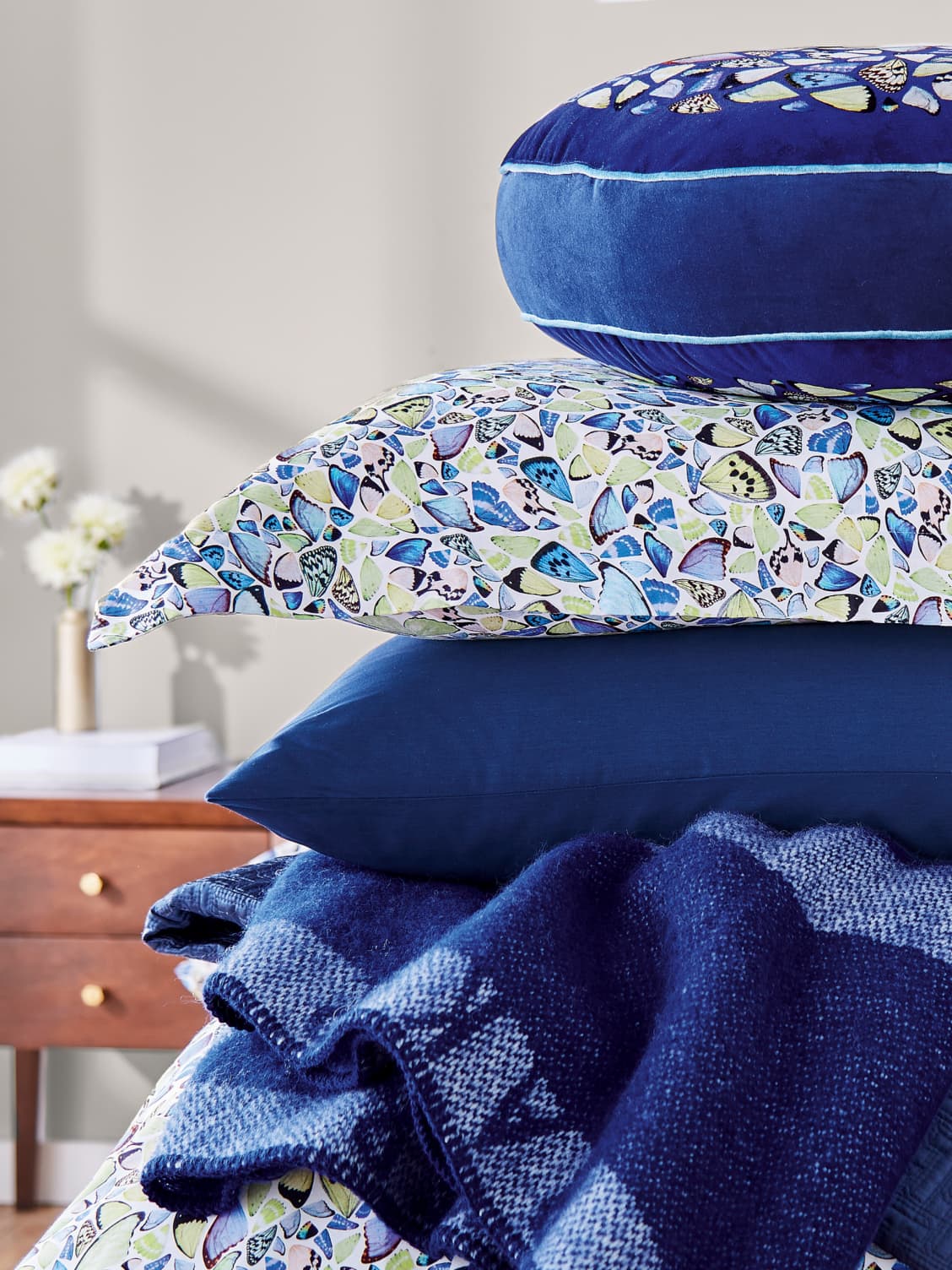 Blue and floral print cushions stacked