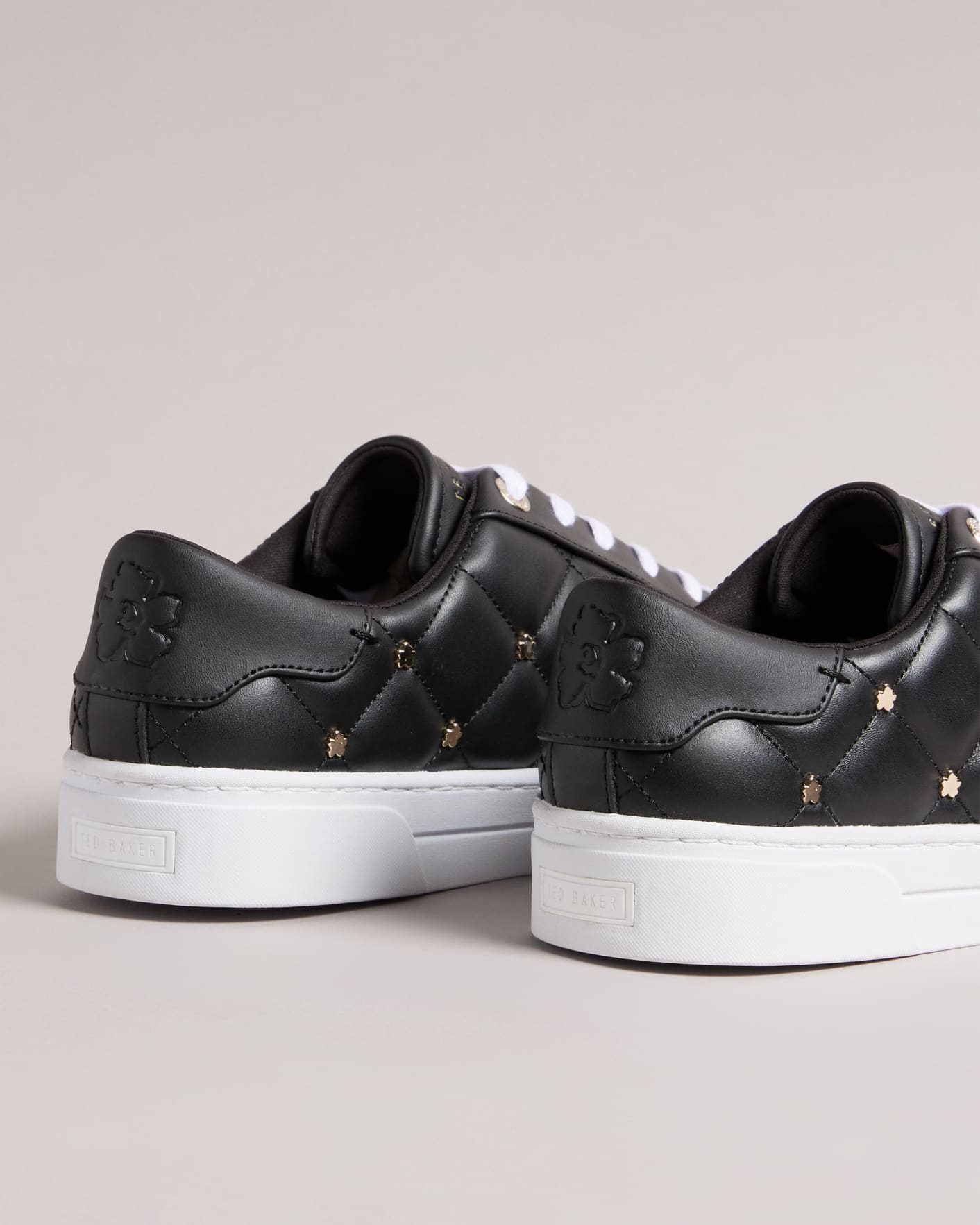 Black Quilted Trainers with Magnolia Studs Ted Baker